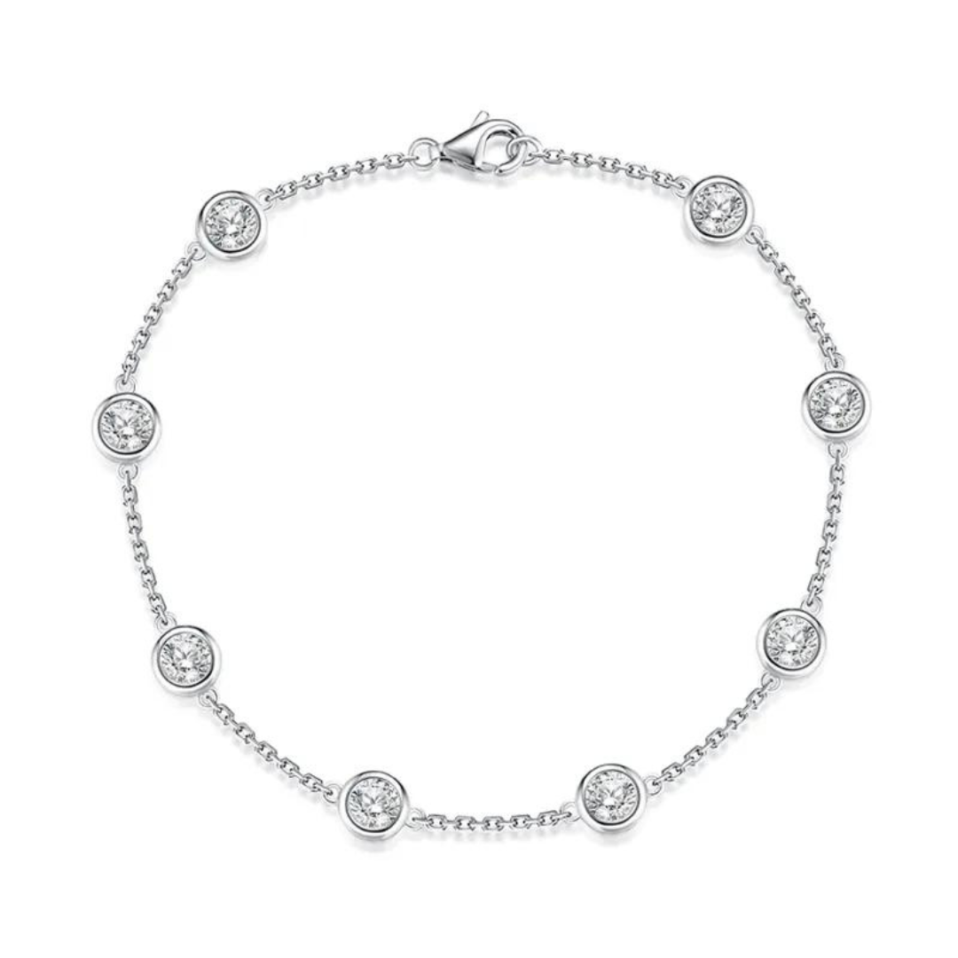 Elysia Round Moissanite Bezel Bracelet, material is high quality sterling silver plated in rhodium, and embellished with round cut moissanite gemstones with bezel setting. A perfect everyday bracelet with a classic design. Elejoux offers high quality and long lasting fine jewelry with curated and elegant designs.