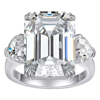 Natalia Luxe Emerald Cut Moissanite Ring features a luxurious emerald cut moissanite gemstone with heart shaped stone flanking either side. The ring is made of high quality sterling silver plated in 18K white gold. This beautiful ring is sure to dazzle with lots of sparkle for any occasion. It's the perfect piece of jewelry for the modern woman as a diamond alternative.