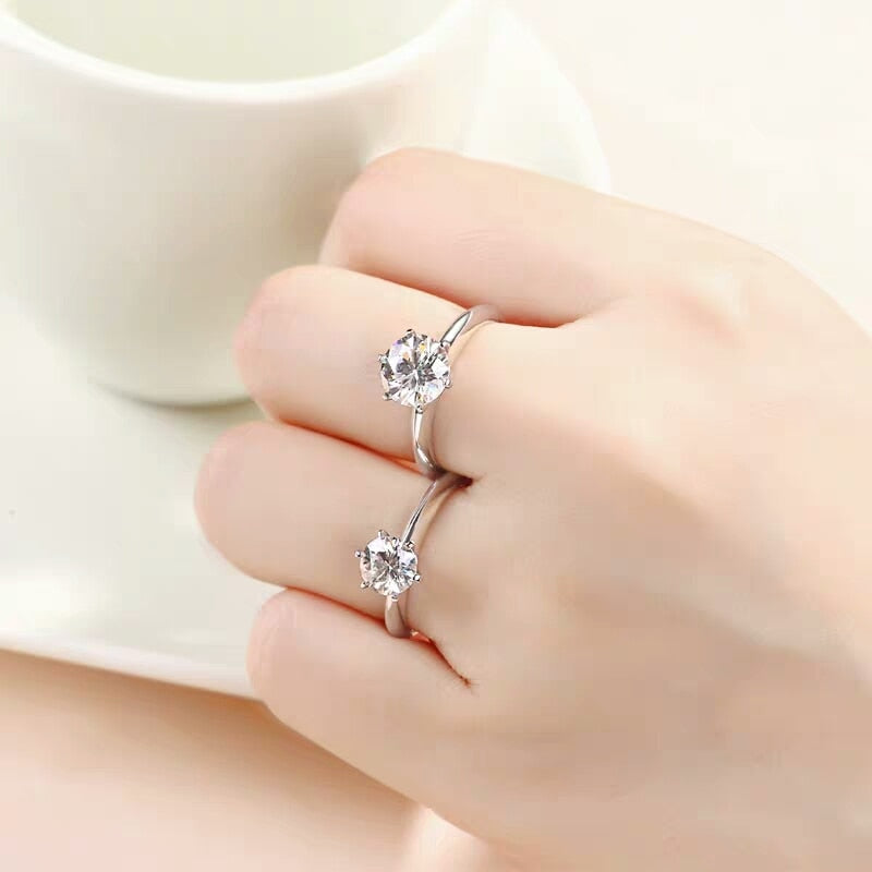 Lyra Round Moissanite Solitaire Ring is a perfect diamond alternative. Set in a 6-prong setting with high quality sterling silver plated in white gold. This ring is sure to dazzle as moissanite gemstone has even more fire than diamond. The beautiful ring comes in a variety of stone sizes for you to choose from.