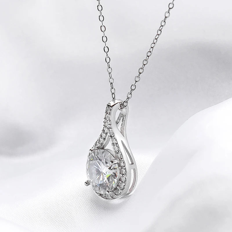 Hebe Teardrop Moissanite Pendant Necklace - round cut moissanite gemstone surrounded by zircon gemstones in teardrop shape. Metal is high quality sterling silver plated in platinum. Elegant design, sparkly necklace, fit for every occasion.