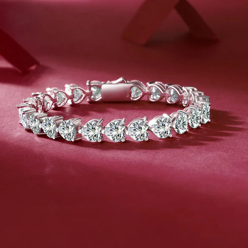 Olivia Heart-shaped Moissanite Bracelet featured expertly cut moissanite gemstones into heart shapes, set in high quality sterling silver plated in platinum. This is a luxurious tennis bracelet perfect for special occasions. The bracelet is crafted with the highest standard of quality and will last a lifetime. Join the Elejoux family and enjoy wearing beautifully crafted fine jewelry with elegant style and high quality.