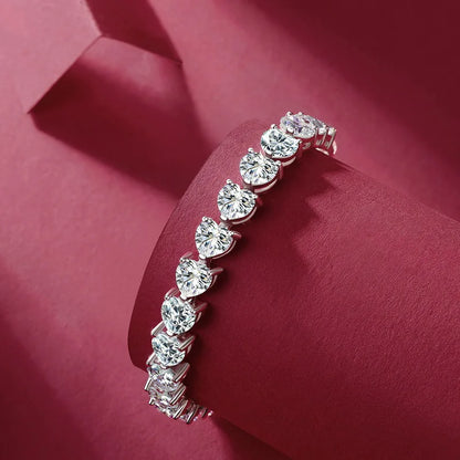 Olivia Heart-shaped Moissanite Bracelet featured expertly cut moissanite gemstones into heart shapes, set in high quality sterling silver plated in platinum. This is a luxurious tennis bracelet perfect for special occasions. The bracelet is crafted with the highest standard of quality and will last a lifetime. Join the Elejoux family and enjoy wearing beautifully crafted fine jewelry with elegant style and high quality.