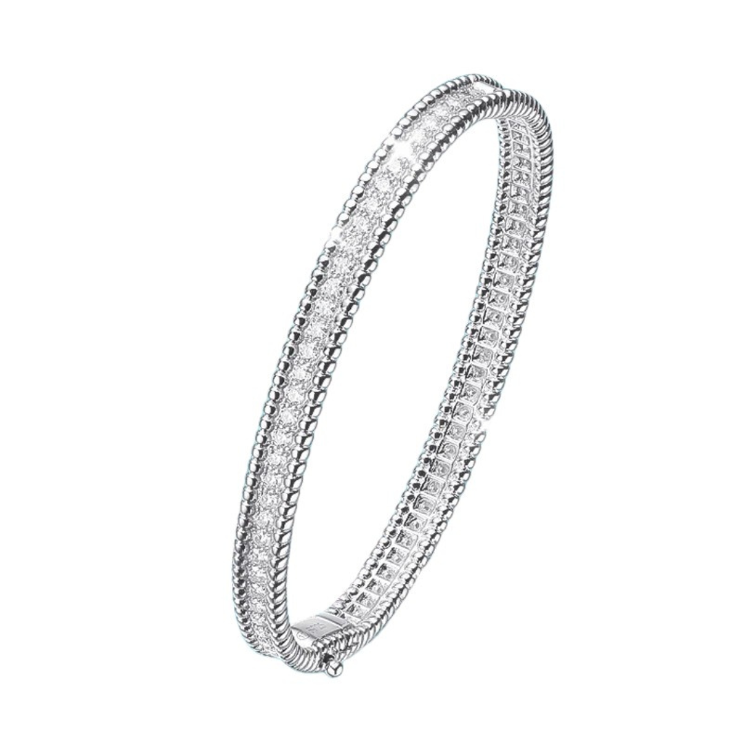 Introducing the Stella Moissanite Bangle: a luxurious piece crafted with 2.28CT of brilliant moissanite stones, set in sterling silver plated with 18K white gold in a secure 4-prong setting. Its timeless elegance and durability make it perfect for special occasions, while its superior shine rivals that of diamonds. Elevate your style with this stunning, environmentally conscious jewelry choice from Elejoux.